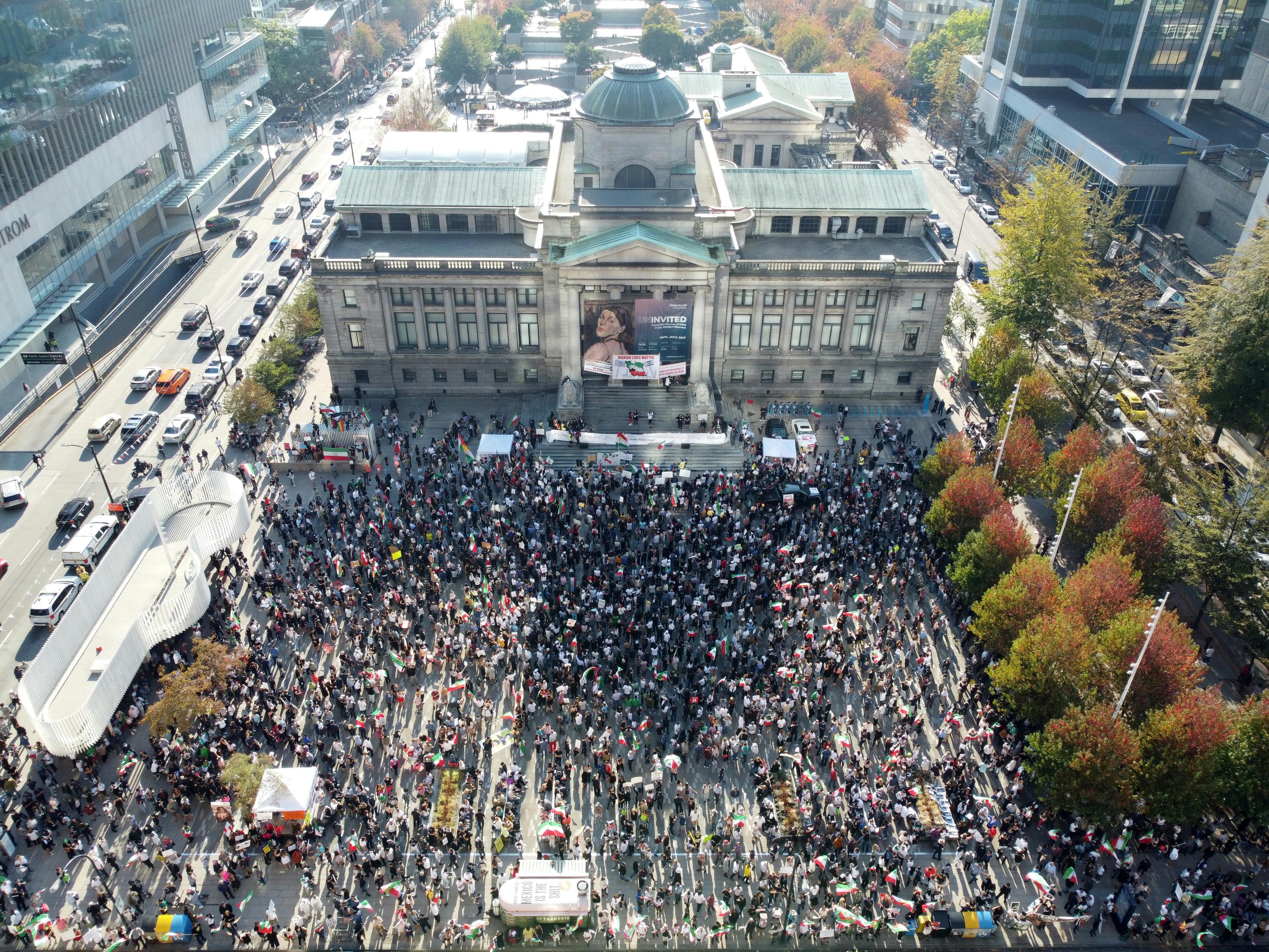 Aerial view of a large protest in front of the Vancouver Art Gallery.