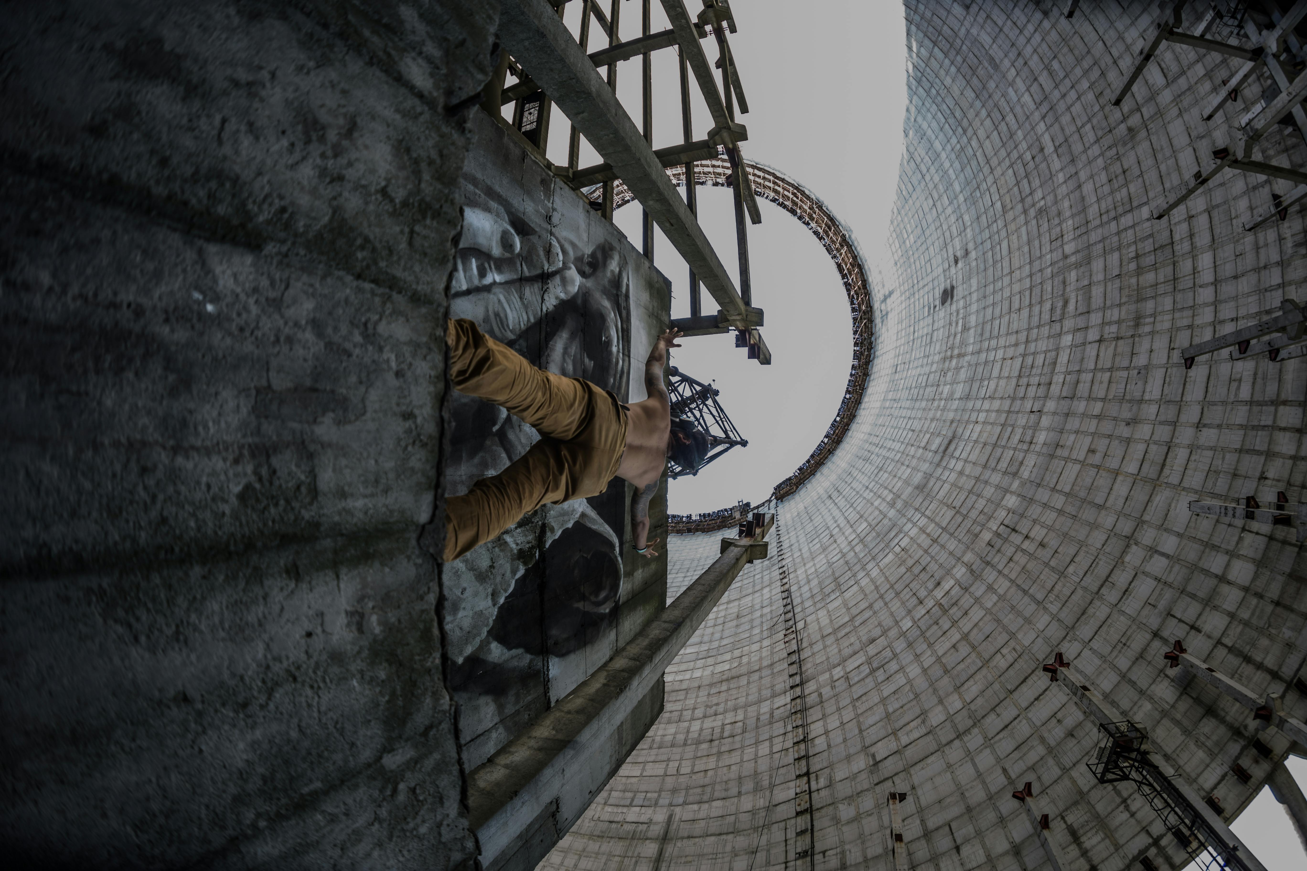 A daring man climbs inside a massive cooling tower in Pryp'yat', Ukraine.