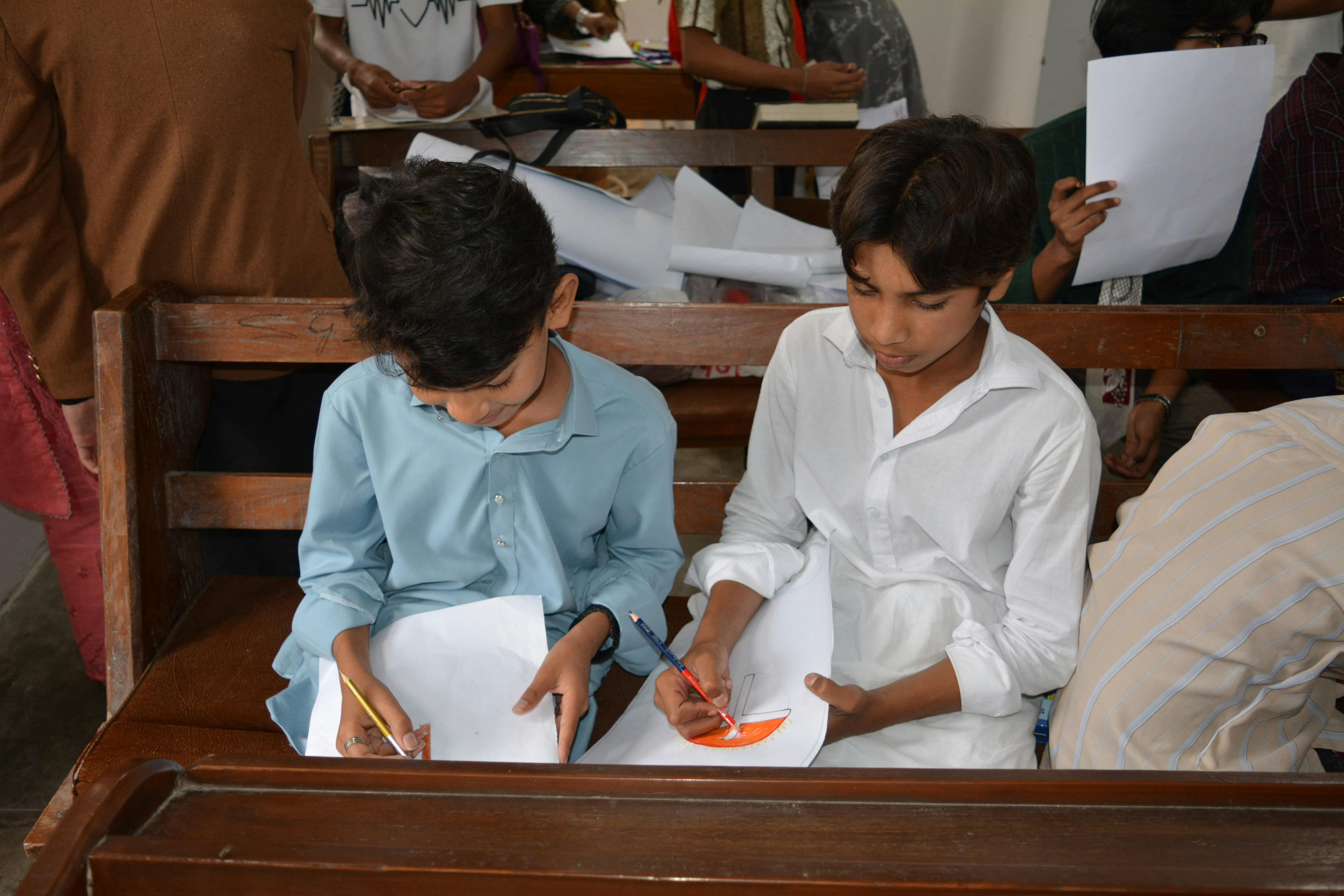 Boys drawing during Sunday school class at a church in Taxila, Pakistan.