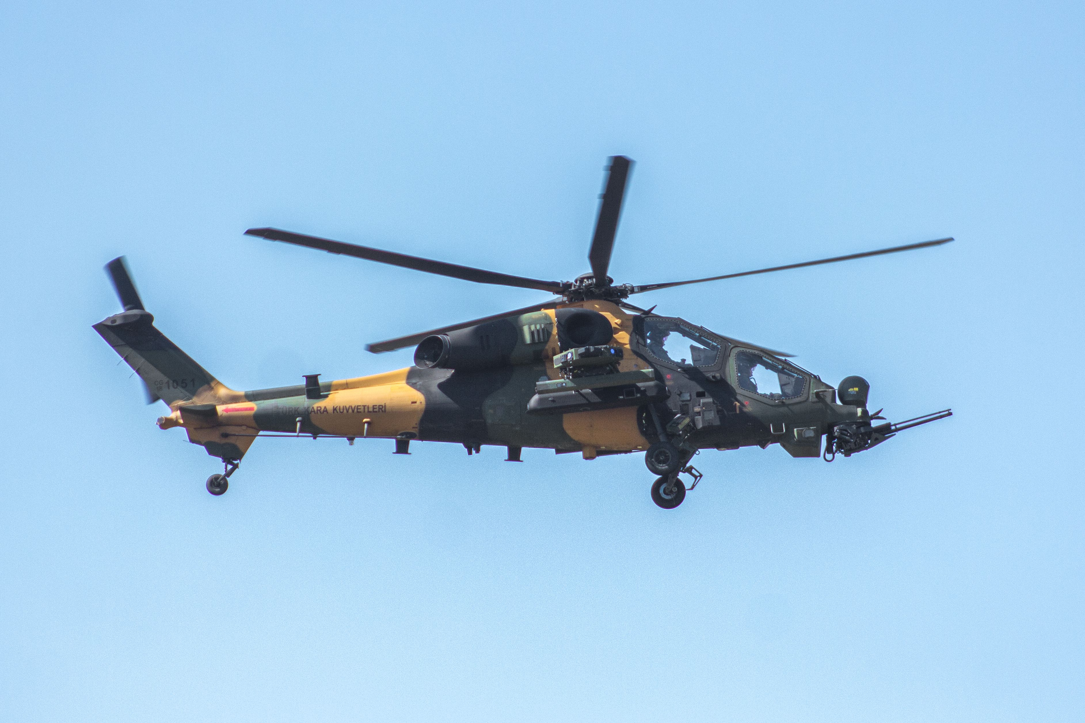 Close-up of a military helicopter flying in clear skies over Adana, Türkiye.